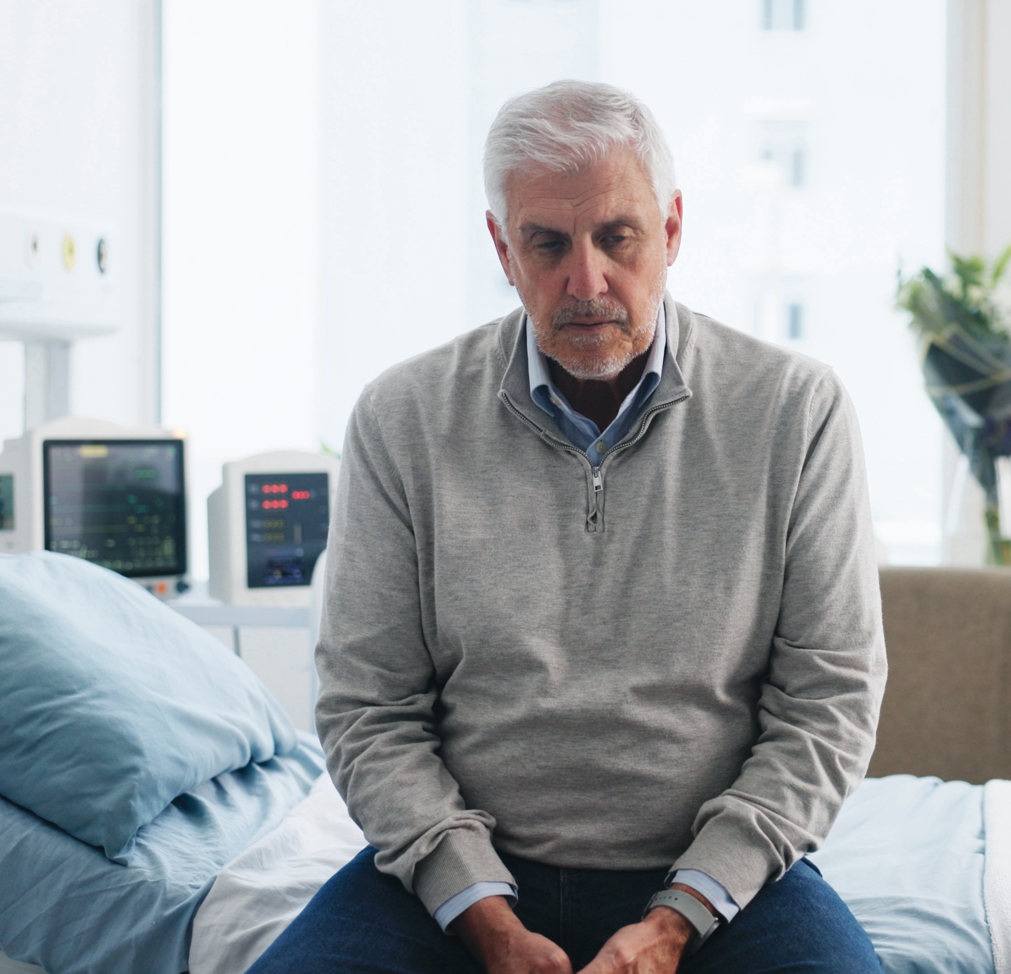 Medical, upset or old man on hospital bed with thinking, appointment stress or waiting for surgery result. Healthcare, anxiety or elderly patient with fear, reflection or diagnosis worry in checkup