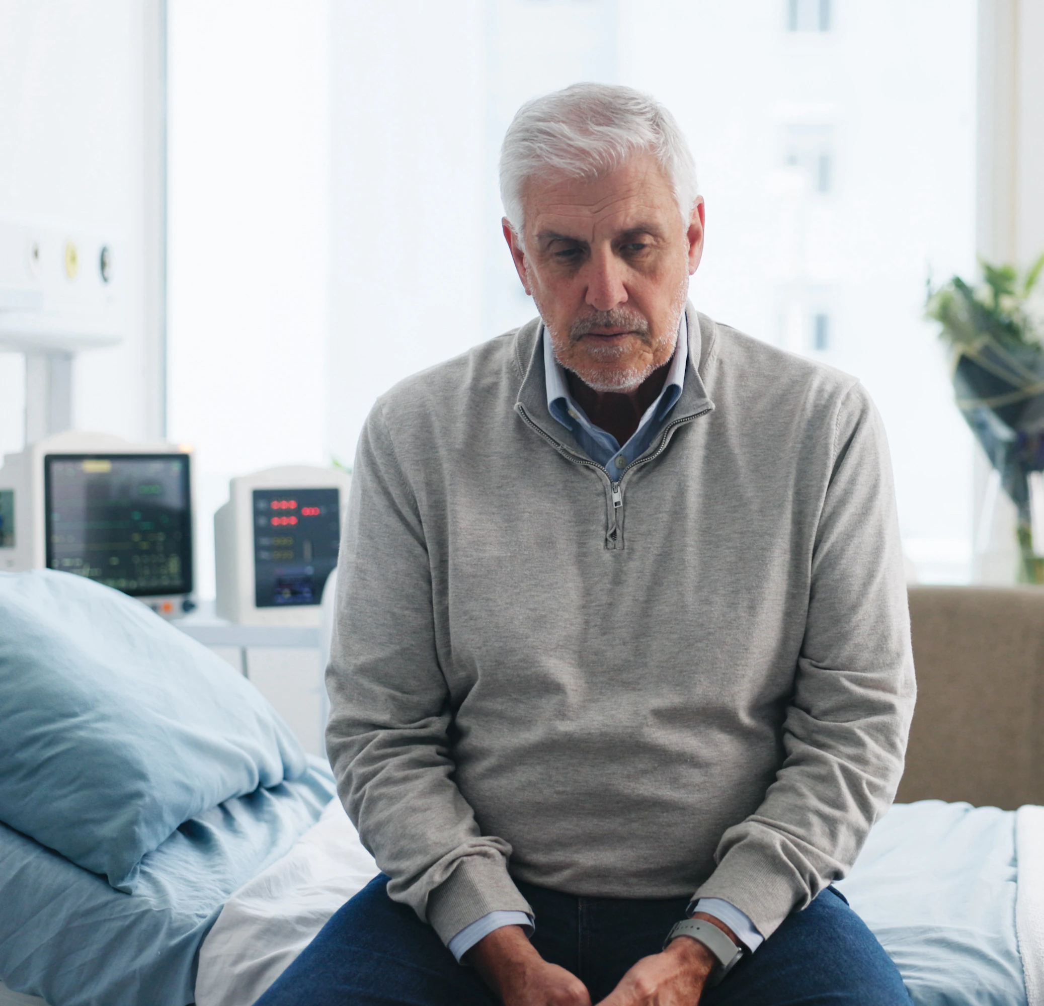Medical, upset or old man on hospital bed with thinking, appointment stress or waiting for surgery result. Healthcare, anxiety or elderly patient with fear, reflection or diagnosis worry in checkup