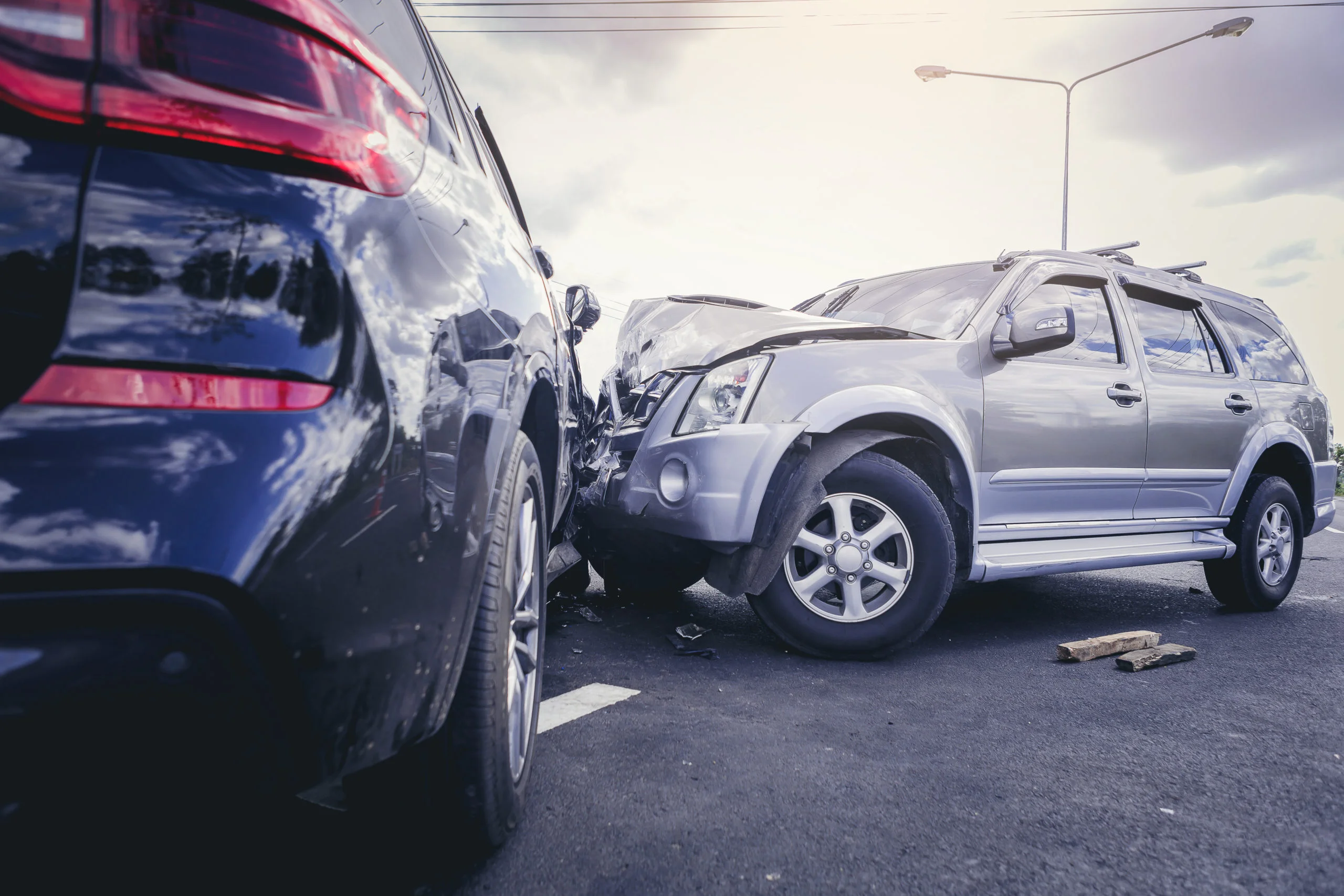 Car crash dangerous accident on the road. SUV car crashing beside another one on the road.