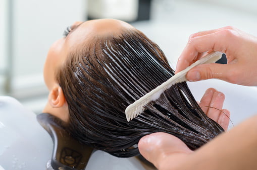 Hair relaxer products that potentially cause cancer are applied to hair.