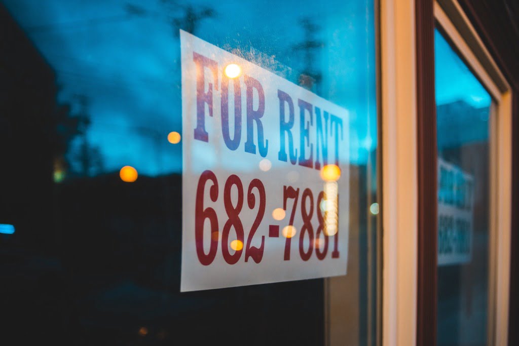 for rent sign hanging in a landlords window