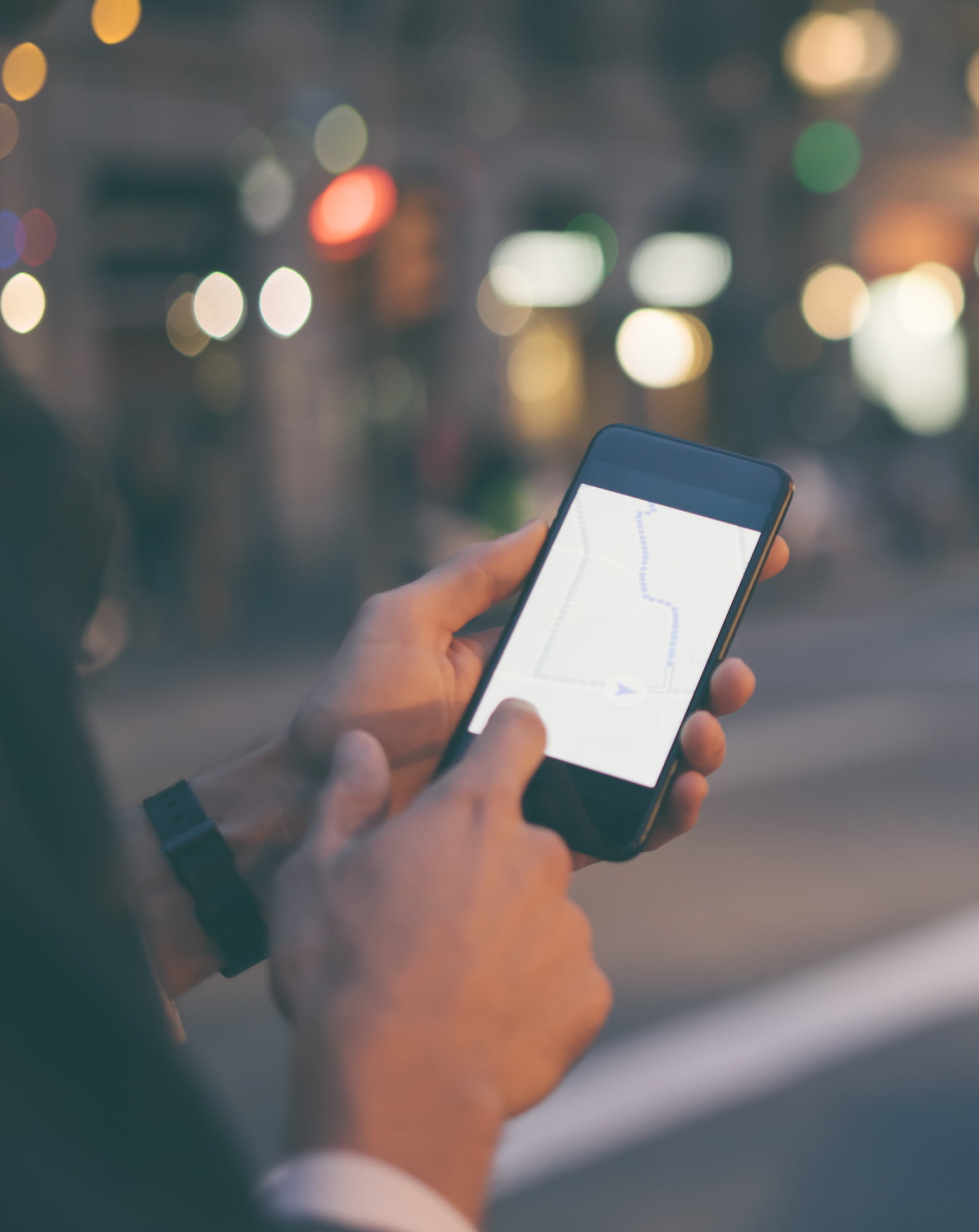 Close up of male hands with smartphone. Tourist using GPS map navigation on application screen for direction to destination address in the city. Travel and technology concept