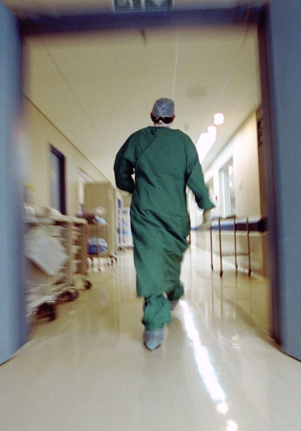 78614308 Doctor rushing in hallway